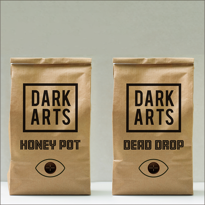 Two brown paper coffee bags labeled 'Honey Pot' and 'Dead Drop' from Dark Arts.
